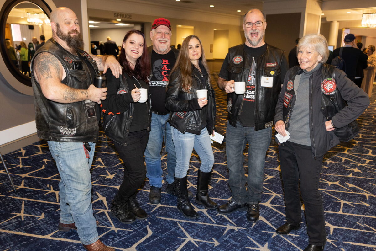 Bikers Against Child Abuse (BACA) group smile and pose at KCSARC fundraising event.